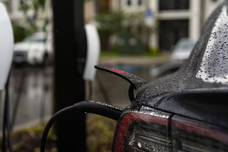 Electric car charging. Charging station to recharge battery with electricity by EV charger cable. EV...