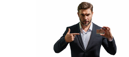 Handsome man holding credit card. Middle aged man in suit with credit card isolated on white studio background. Credit bank card concept. Businessman in business suit pay by credit card.の写真素材