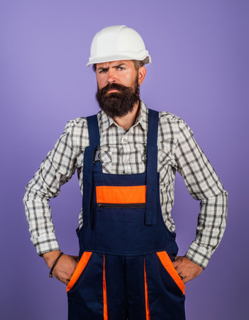 Builder worker in construction helmet. Builder foreman or repairman in builders uniform. Worker in studio. Construction manager, builder in helmet. Male builder engineer.の写真素材