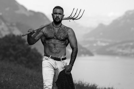 Muscular man. Rural guy. Naked body of strong farmer guy on countryside village. Six pack abs...