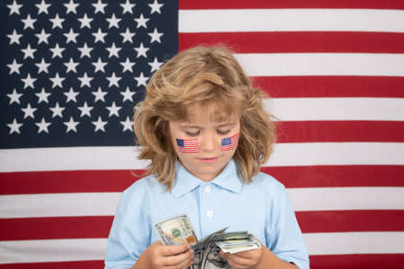 American dollars money banknotes concept. Kid having a lot of hundred dollars isolated on studio...