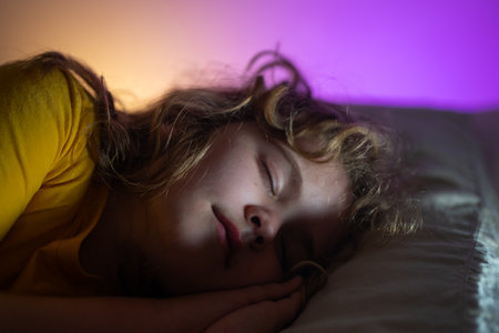 Child sleeping in a bed. Cute kid sleep. Kids pillow and blanket for sleeping. Little boy sleeps. Adorable kid sleeps in bed. Sleeping child. Kid sleeping in dark bedroom.の写真素材
