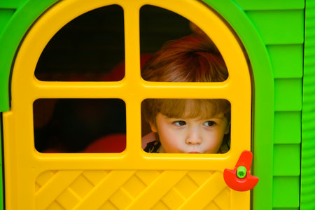 Portrait of kid in spring park outdoors. Close-up face child playing outdoors in summer park.の写真素材