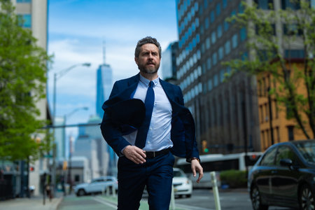 Business man run in NY. American business. Businessman run down street, late for a meeting. Businessman in suit run be success. Running business man. Fast business. Run and late businessman.の写真素材