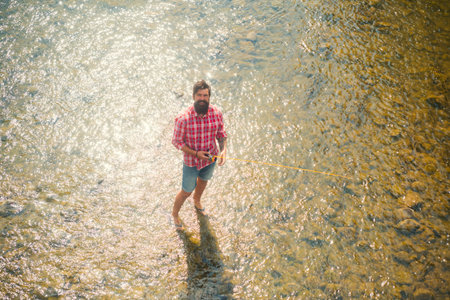 Standing alone during the fishing. Elegant bearded man. Fishing requires to be mindful and fully...