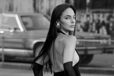 Woman posing near luxury american retro car outdoor. Sensual women and fashion concept. Fashion...