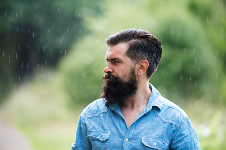 Man under rain. Autumn rainy weather concept. Waterproof wear.の写真素材