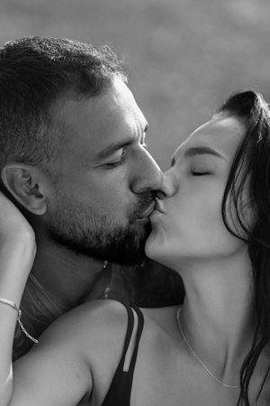 Portrait of young couple kissing. Couple kissing, close up. Sensual kiss. Tender kiss. Couple in love kissing on the nature. Sensual couple on nature. Romantic kiss. Beauty kiss.の写真素材