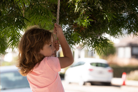 Portrait of kid boy in nature, park or outdoors. Close up face of happy child playing outdoors in summer park.の写真素材