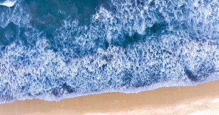 Beach view from drone. Blue ocean wave on sandy beach. Sand beach aerial, top view of a beautiful...