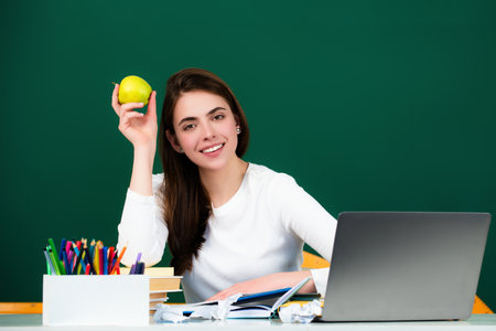 The student girl is studying in the classroom. Student teenager girl learning in the classroom. The student girl is in class at school. College, high school or university students.の写真素材