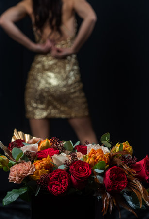 Bouquet of flowers. Woman undressing near red rose flower.の写真素材