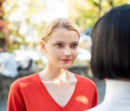 Girlfriends each other with love. Two beautiful women look romantic. Lovely female couple standing face to face. Best friends, friendship. Lovely women sharing a tender face-to-face.の写真素材
