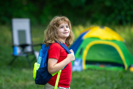 Child on picnic or nature trip in summer. Kid Fun on camping. Little tourist on nature. Child enjoying summer camp. Kid exploring nature outdoors. Happy child on a camping trip. Picnic with kids.の写真素材