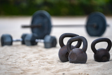 Sports equipment. Kettlebell, barbell and dumbbells for summer sport. Outdoor sport. Fitness workout in public sport gym. Lifting weights. Healthy lifestyle. Fitness outdoors. Sport background.の写真素材