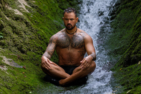 Meditation. Harmony and peace in nature. Calm man meditating in environment. Mindfulness. Relaxed man in nature. Freedom and happiness. Muscular fit man practicing yoga outdoors.の写真素材