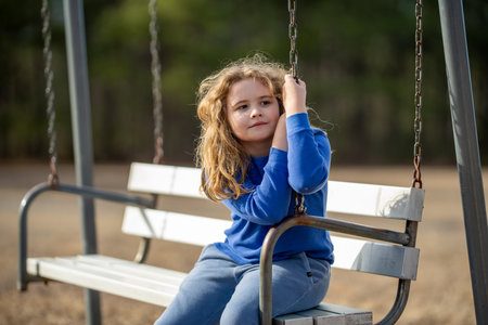 Child mind full of imagination. Blonde child thinking peacefully. Little dreamer. Child imagining concept. Outdoor kids portrait. Dreamy child face. Kids dreamy expression. Kids face with inspiration.の写真素材