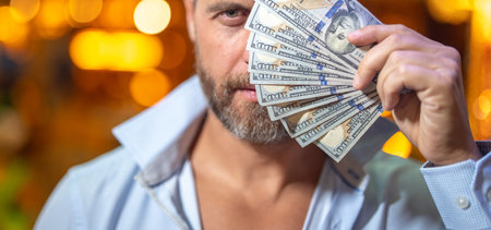 Rich businessman holding cash. Successful rich man counting dollar bills. Rich guy with dollar bills. Successful man showing dollars money. Rich man holding banknotes. Financial success. Cash money.の写真素材