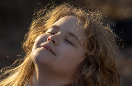 Kid mind full of imagination. Blonde child thinking peacefully. Little dreamer. Child imagining concept. Outdoor kids portrait. Dreamy kids face. Kids dreamy expression. Kids face with inspiration.の写真素材