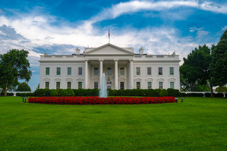 White House in Washington DC. The White House under blue sky. American presidents residence. Iconic White House building. Federal government. The White House and American flag.の写真素材