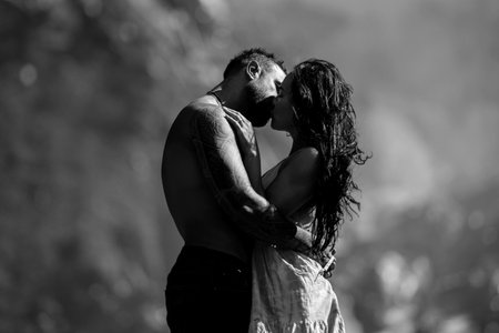 Romantic couple in love embraced passionately on the nature. Romantic Couple kiss on nature. The romantic couple in love on summer nature. Outdoor portrait of Romantic couple. Tender kiss on nature.の写真素材
