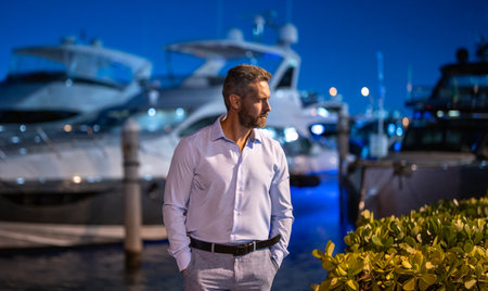 Rich billionaire man near yacht. Wealthy charismatic billionaire business man with luxury lifestyle. Billionaire man on private yacht. Financial freedom. Expensive yacht with billionaire business man.の写真素材