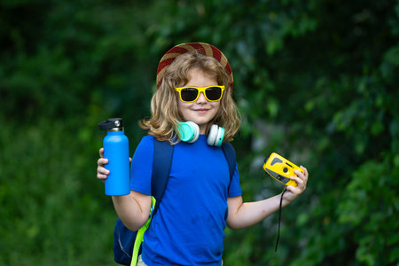 Child enjoying summer camp. Kid exploring nature outdoors. Happy child on a camping trip. Picnic in...