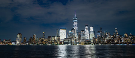 Manhattan skyscrapers at dusk. NY cityscape with lights. Night in New York. NYC night cityscape. Downtown Manhattan. New York at twilight. American city. New York City skyline. NYC skyscrapers.の写真素材