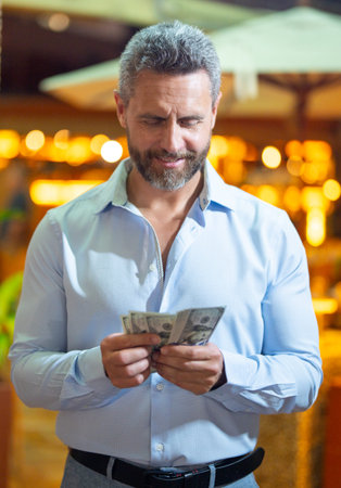 Business man holding money cash. Businessman with money. Man counting dollars bills money. Wealthy...