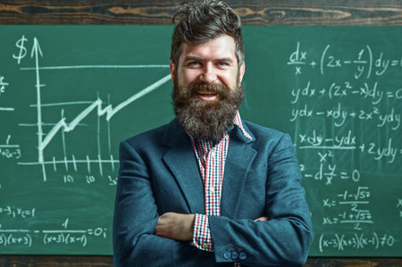 Teacher explains math in class. Professor in classroom on math lesson. School teacher writes math...