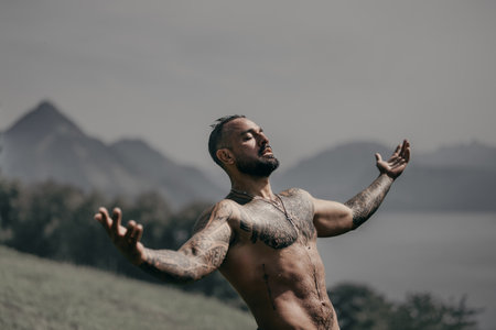 Man on nature. Shirtless man under waterfall. Fit and strong male body in nature. Model enjoying summer. Man beauty. Muscular man with water drops torso.の写真素材