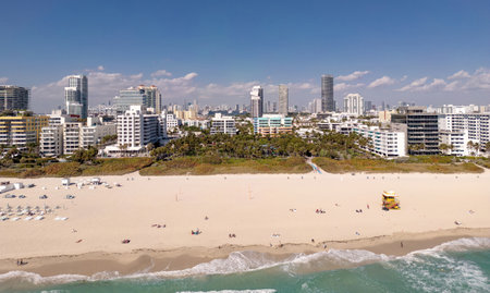 Beach in Miami with sunbed on a sandy beach with ocean waves. Miami Beach paradise with stunning views. South Beach Miami lifeguard post. Peaceful seaside retreat in Miami. Coastal relaxation.の写真素材