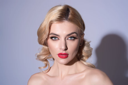 Beauty woman with fashion eyes make up, red lipstick on plump lips, blonde hair, close up face. Beauty face of young woman with natural healthy skin. Beautiful female portrait.の写真素材