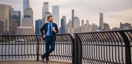 Boss. Handsome mature businessman walk outside. Businessman walking on the street in New York. Gray businessman with beard in business suit in city street in NYC. Manager near Manhattan street.の写真素材