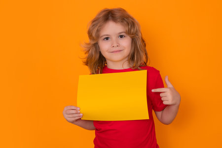 Kid showing blank banner on isolated background. Advertising billboard, placard. Child hold empty...