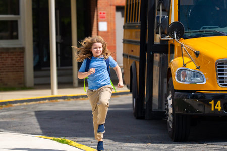 School bus waiting for child student outdoors. Kid with backpack and books to go school. Outdoor...