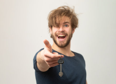Key concept. Keys to success. Funny guy got the key. Funny security concept with key. Confused guy posing with safety keys. Man with key and funny expression.の写真素材