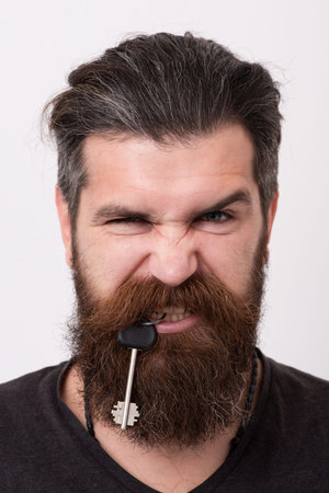 Key concept. Keys to success. Crazy homeowner. Funny bearded man got the key. Funny security concept...