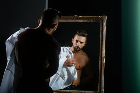 Handsome man with perfect muscular body. Shirtless muscled male model. Muscular handsome guy with strong body. Sport muscle guy. Man with naked torso, muscles guy.の写真素材