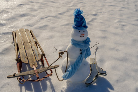 Snowman winter background. Snow holiday scene. Festive snowman with scarf. Snowy design. Happy snow-man with hat. Christmas banner. Frosty snowman. Winter greeting postcard. Cute snowman.の写真素材