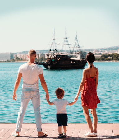 Young family enjoying summer by the sea. Father, mother, and child on summer vacation. Sea for happy family. Loving parents and kid on summer leisure. Family summer vacation. Young family.の写真素材