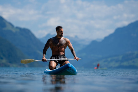 Shirtless muscular man swimming in a lake. Handsome athlete enjoying water in nature. Fit male model...