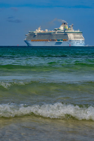 Cruise ship on the ocean. Luxury liner at ocean waves water. Miami Beach with cruise ship. Turquoise water and cruise liner. Tourist cruise ship near the coast. Ocean waves and vessel boat.の写真素材