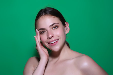 Beauty face of young brunette woman. Sexy model posing in studio. Portrait of beautiful girl. Beauty woman face closeup. Pretty girl face on studio background. Sensual look. Beautiful female face.の写真素材
