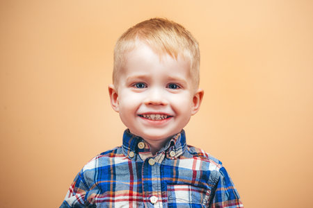 Laughing child with fun expression. Portrait of a happy kid smiling. Cute child with laugh. Closeup of kids cheerful face. Portrait of laughing child. Happy kid with a smile. Kids face with happiness.の写真素材