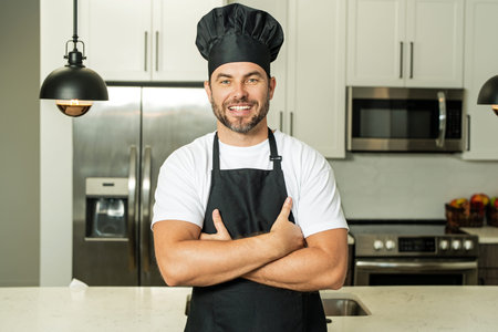 Man in chef apron cooking on kitchen.