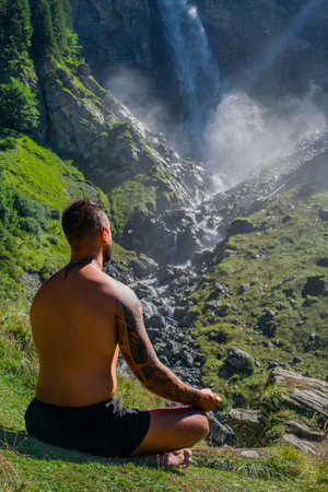Man meditation. Sport model relax in nature. Meditation, spiritual wellness. Calm athlete meditation man training mindfulness. Relax and meditation in nature. Calmness and relax in nature.の写真素材