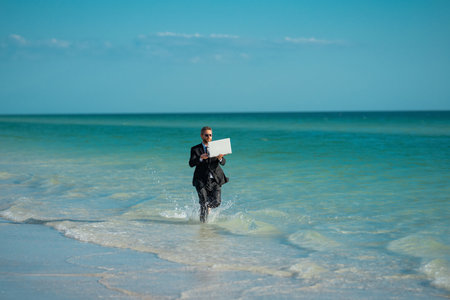 Businessman suit barefoot running on beach. Handsome business man on summer vacation. Businessman...