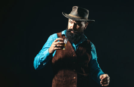 Brandy scotch glass held by serious man. Guy drinking brandy scotch alone at bar. Brandy scotch cognac in classic vintage glass. Brandy scotch tasting with retro style. Liquor concept.の写真素材