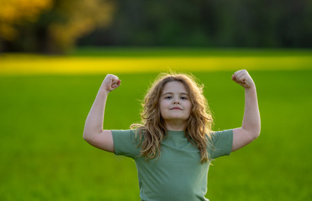 Close-up portrait of kid in summer. Kids face. Summer portrait of happy child. Child face in park. Portrait of cheerful kid outdoors. Fun face of child. Child enjoying summer. Summer vibes.の写真素材
